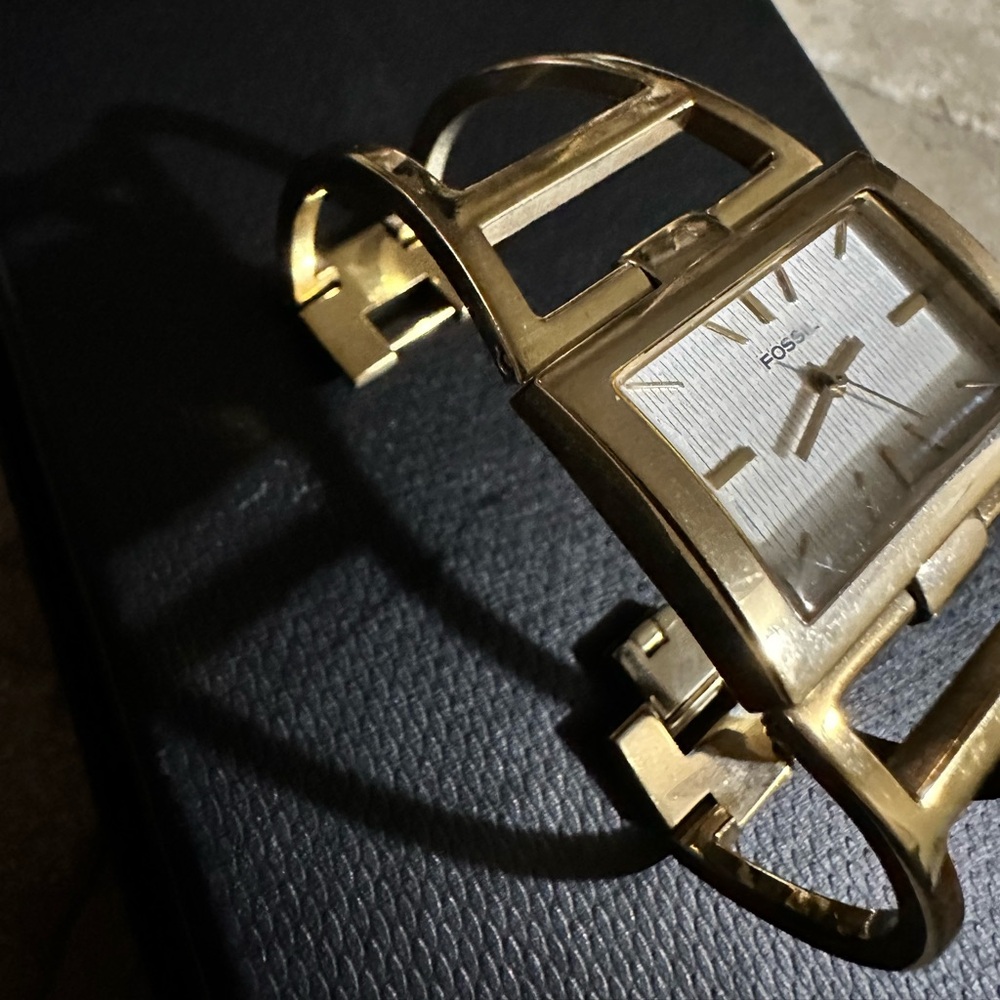 Fossil watch with open face gold bangle band